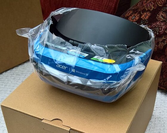 Acer headset still in its plastic wrapping on top of the box